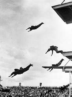 German soldiers dive in full field equipment in a pre-game show at Olympic swimming trials at Halberstadt. July 27, 1936.