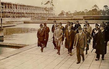 Dr. Carl Diem (front, far right) and Dr. Theodor Lewald (front, center) were key figures in the German Olympic movement. They lobbied hard to bring the Games to Berlin. Neither was a member of the Nazi Party, but they were co-opted by the Nazis in planning the 1936 Olympics. They are shown here with Hitler surveying the grounds of the Olympic stadium in Berlin. Fall 1934.