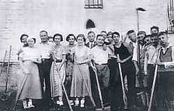 Bergmann (foreground, in black shirt) and other members of her Jewish sports club prepare to transform a former potato field into a handball field. 1933.