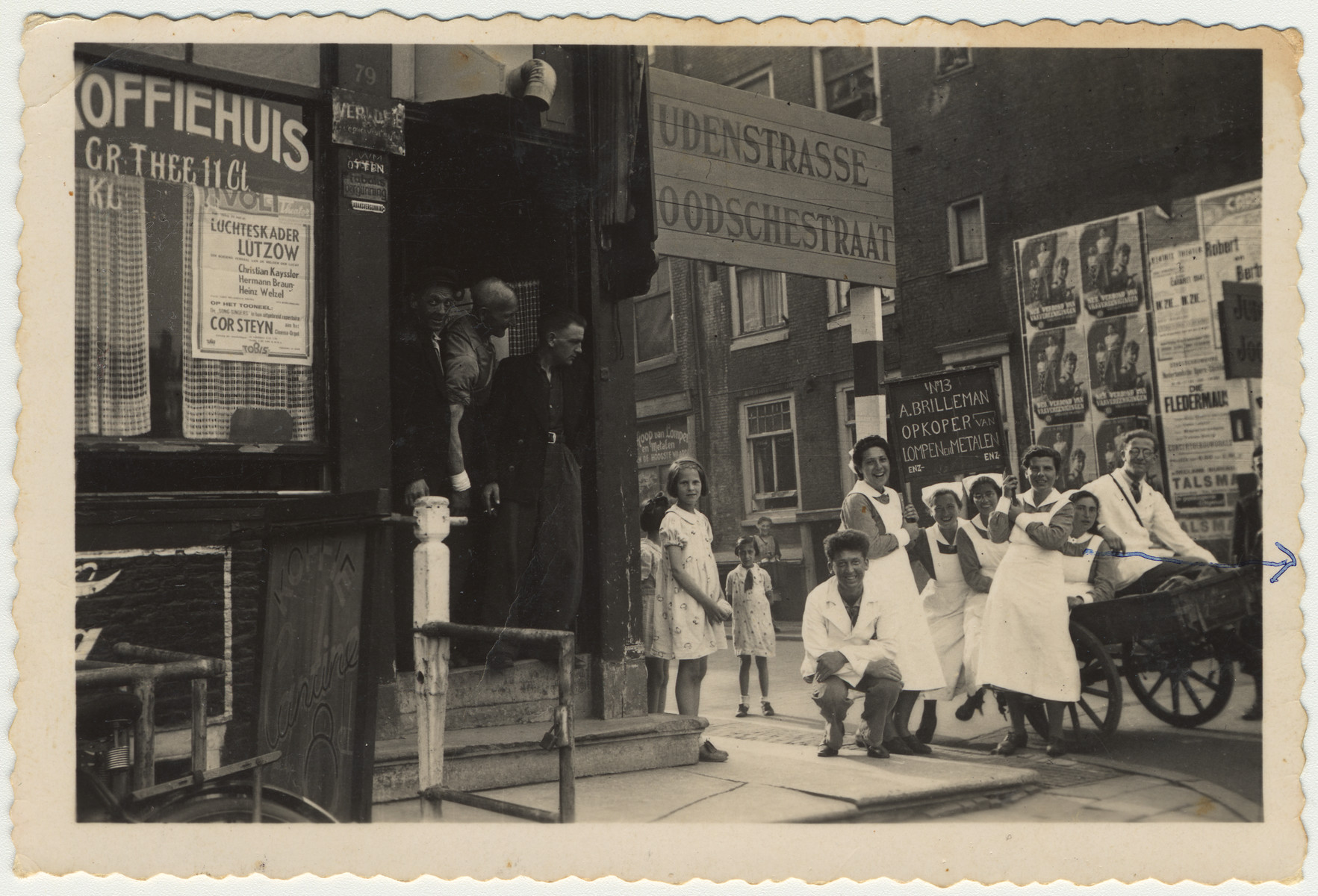 Jewish nurses and nursing students gather around a cart outside a coffee house on the designated Judenstrasse during the Nazi occupation of the Netherlands, ca. 1940-1942