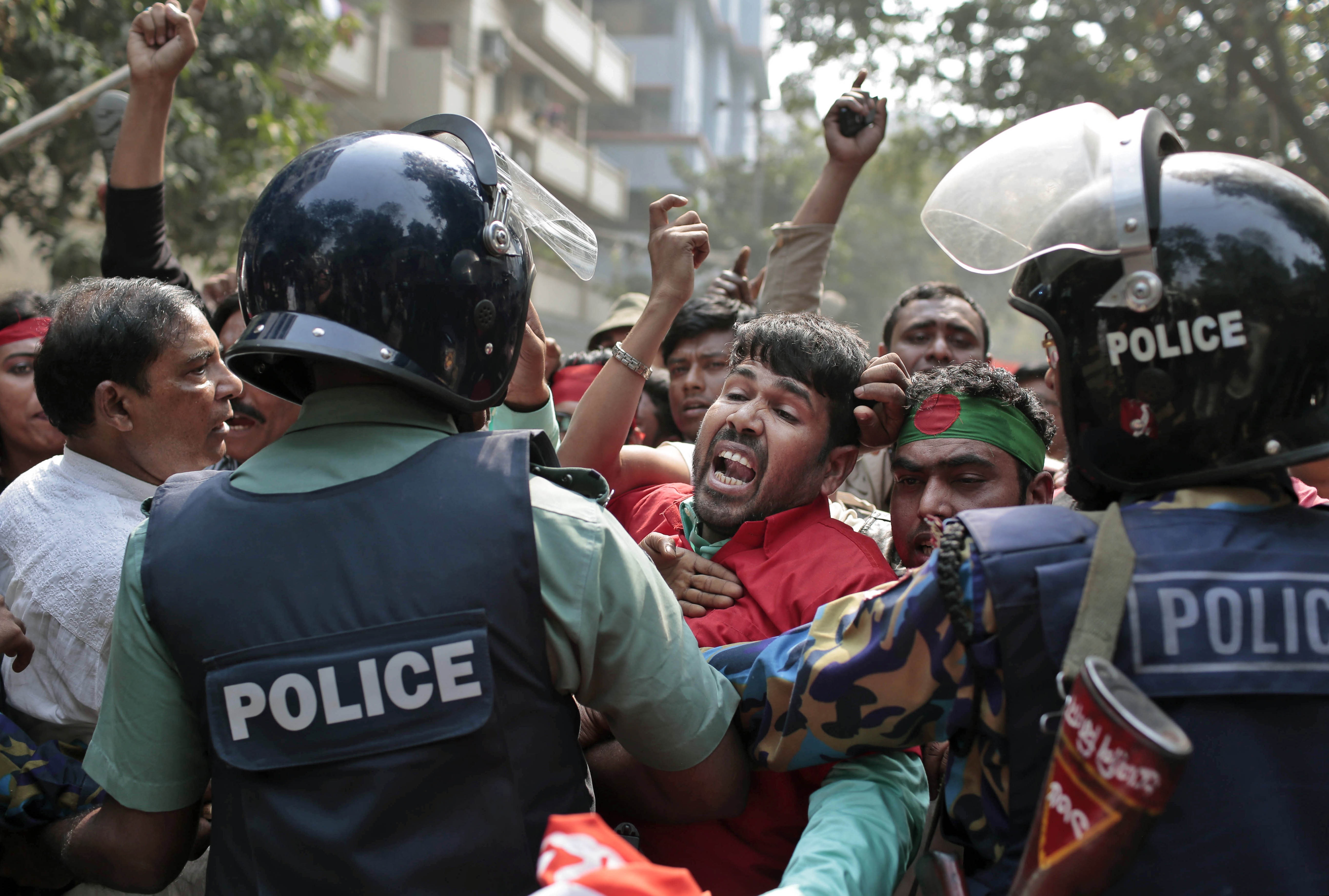 Protesters try to break through a police barricade during a demonstration against a strike called by the opposition in Dhaka, Bangladesh, Monday, Feb. 9, 2015.