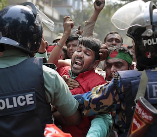 Protesters try to break through a police barricade during a demonstration against a strike called by the opposition in Dhaka, Bangladesh, Monday, Feb. 9, 2015.