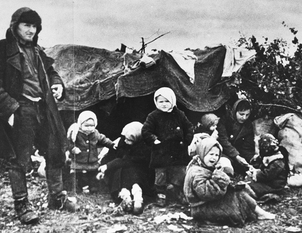 A Soviet refugee family sits in a makeshift shelter.