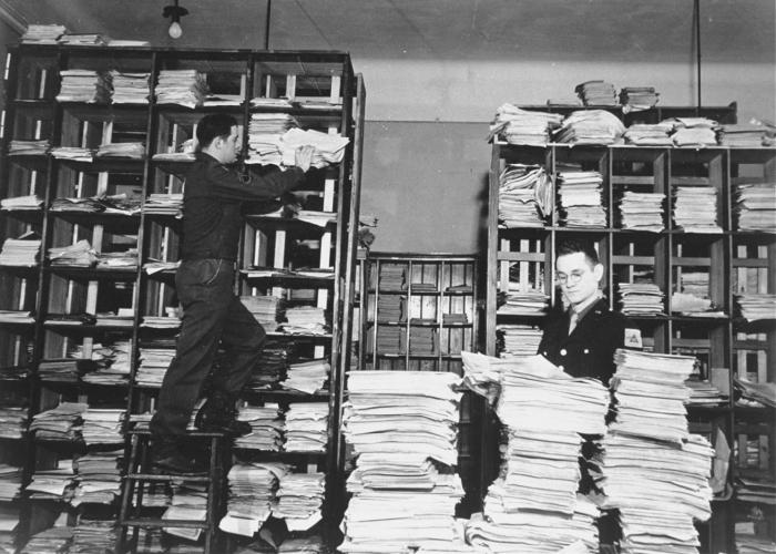 US Army staffers organizing stacks of German documents