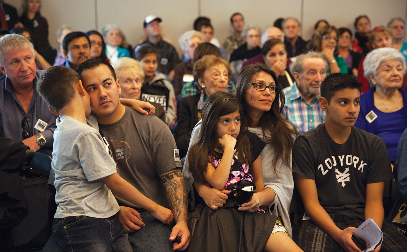 A family with young children listens to a Museum program in Los Angeles