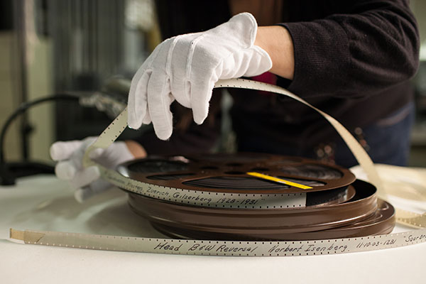 Museum staff works with a film reel