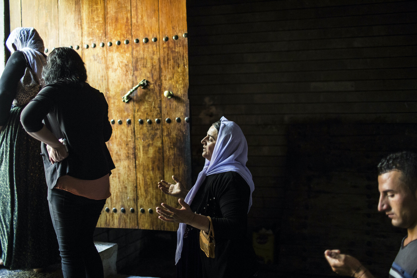 Yezidi pilgrims pray as they leave a sacred temple in Lalish.