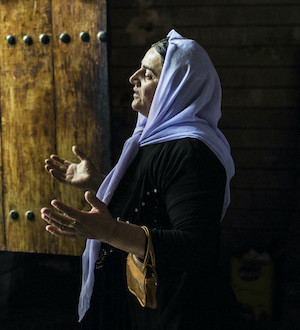 Yezidi pilgrims pray as they leave a sacred temple in Lalish.