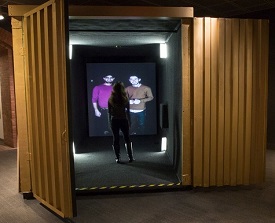 A visitor in the Portal at the United States Holocaust Memorial Museum speaks with Omar and a friend in Berlin’s Tempelhof airport, which provides services to refugees.