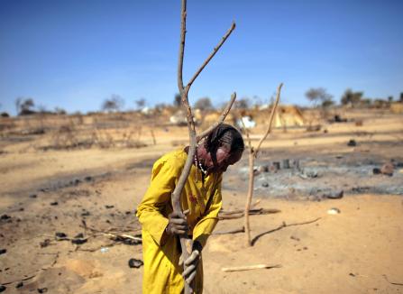 Fadila Ahmed Mahamat amid the burned ruins of her former home.