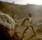 Six-year-old Kuti plays by his grandmother's hut in Sudan's Nuba Mountains.