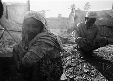 Halima and her father Sayed prepare the meager amount of rice they have, after seven members of their family fled to this displacement camp after anti-Rohingya violence forced them from their homes in October 2012. 