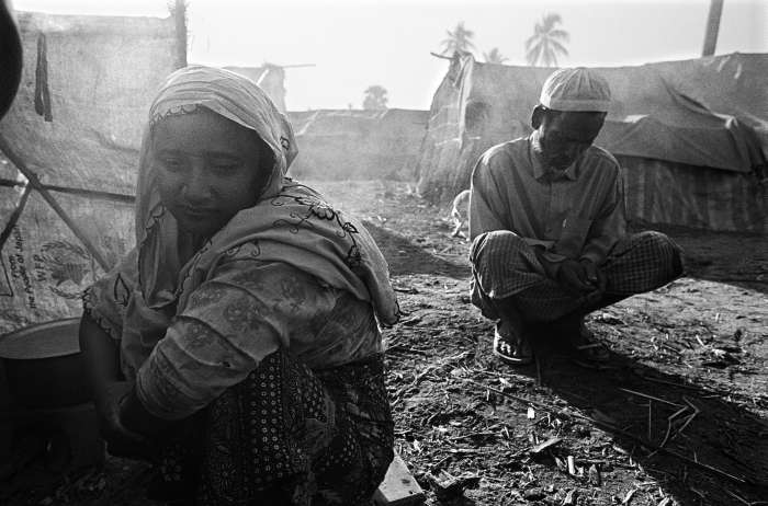 Halima and her father Sayed prepare the meager amount of rice they have, after seven members of their family fled to this displacement camp after anti-Rohingya violence forced them from their homes in October 2012. 