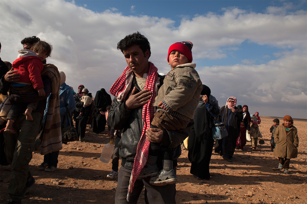 Refugees cross the border from Syria into Jordan