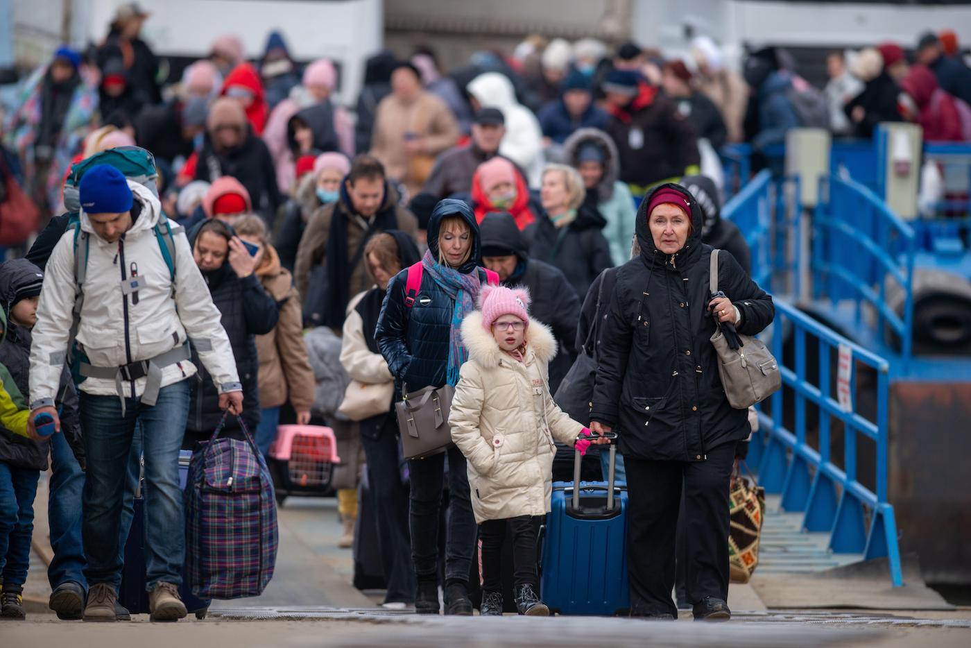 Refugee Ukrainians walk from Ukraine to Isaccea in Romania after crossing the border. March, 5, 2022.