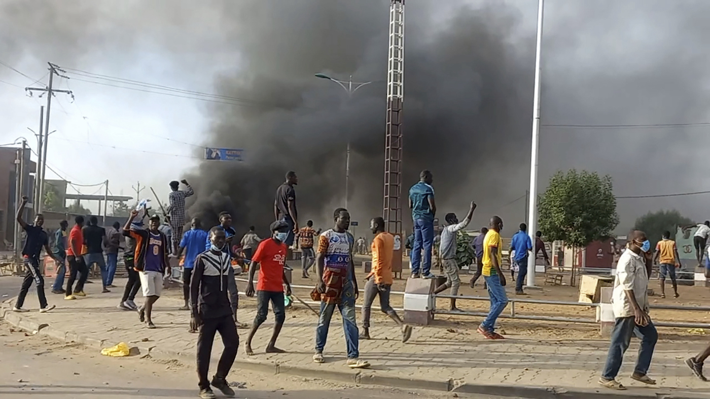 Anti-government demonstrators set a barricade on fire during clashes in N’Djamena, Chad, Thursday Oct. 20, 2022. 