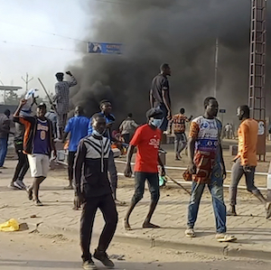 Anti-government demonstrators set a barricade on fire during clashes in N'Djamena, Chad, Thursday Oct. 20, 2022. 