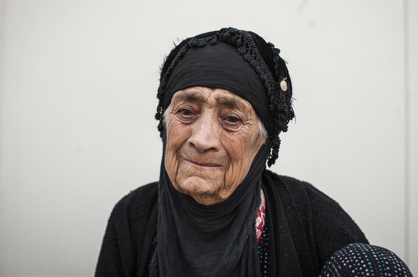 A 91-year-old Iraqi woman tears up as she recounts how she fled from Mosul.