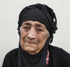 A 91-year-old Iraqi woman tears up as she recounts how she fled from Mosul.