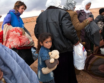 Refugees from the conflict in Syria wait to board a truck to a transit center. The conflict has become the largest humanitarian emergency the world has seen since World War II and international response remains woefully inadequate.