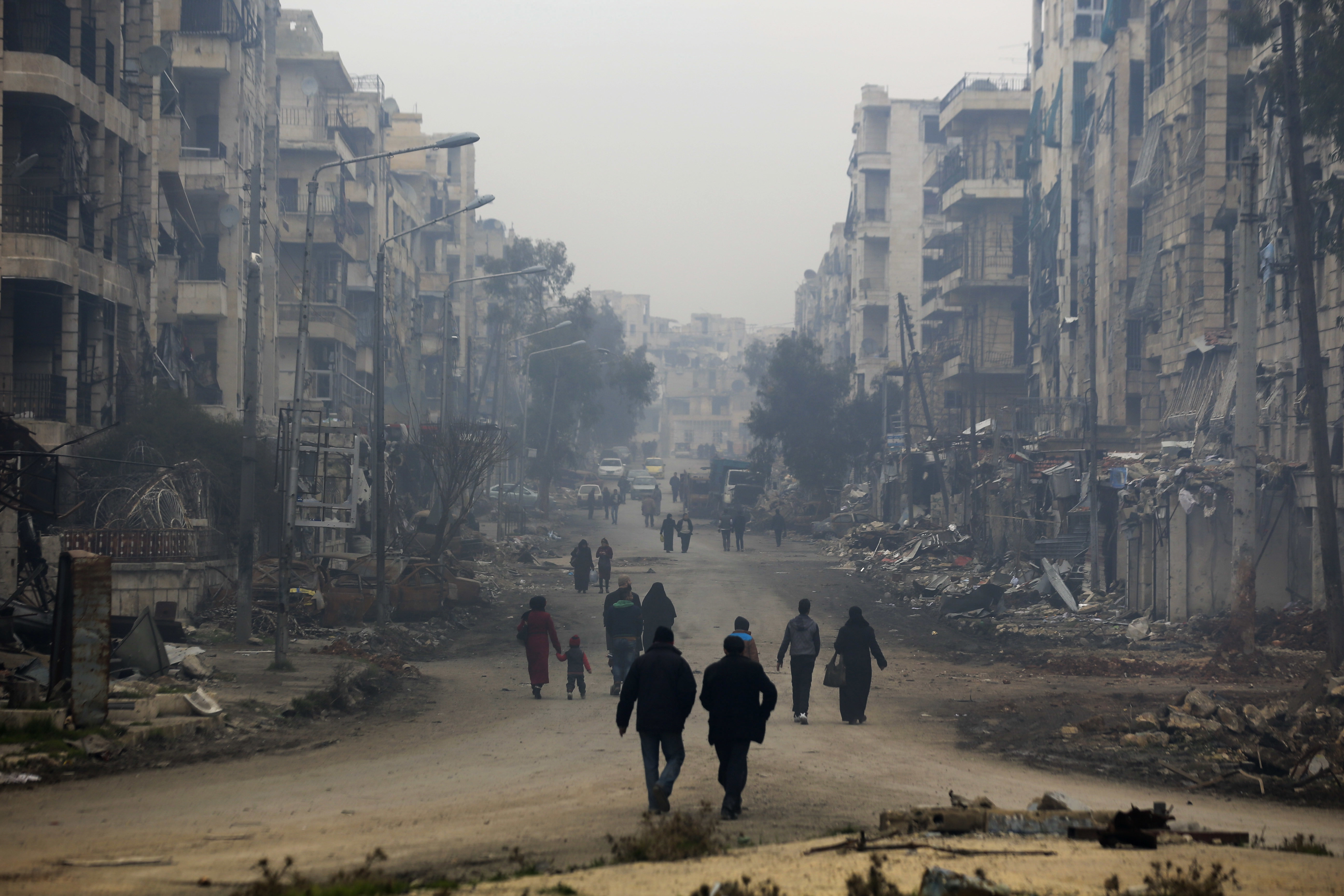 Residents walk through the destruction of the once rebel-held Salaheddine neighborhood in the eastern Aleppo, Syria.