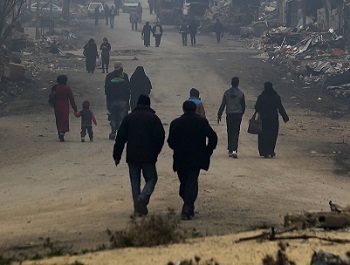 Residents walk through the destruction of the once rebel-held Salaheddine neighborhood in the eastern Aleppo, Syria.