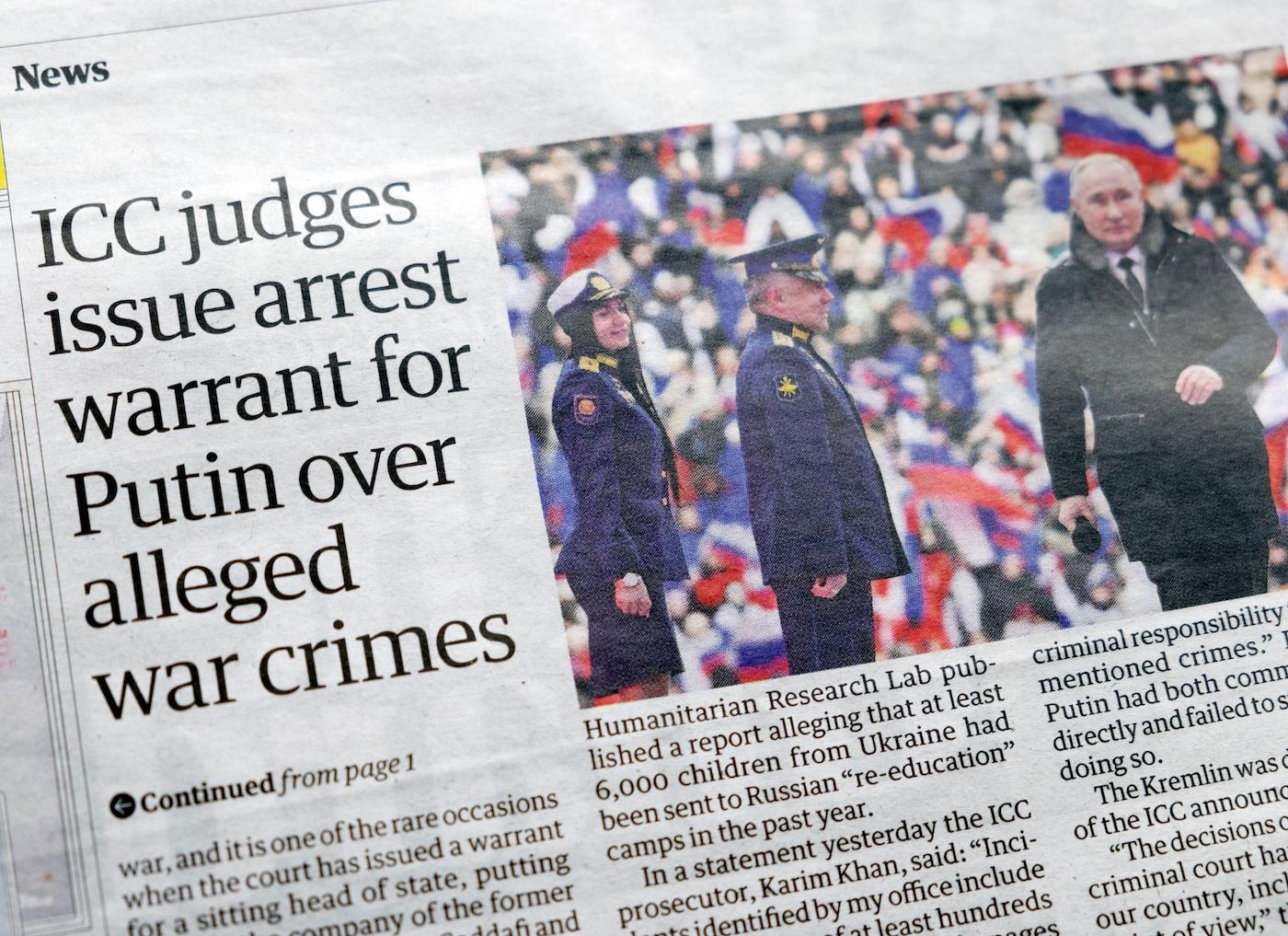 ICC judges issue arrest warrant for Putin over alleged war crimes’ Guardian newspaper headline Russia Ukraine war article on March 18, 2023. London, UK.